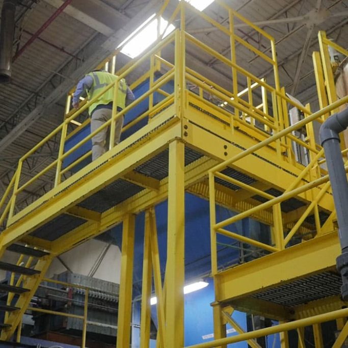Yellow steel fabricated access platform for industrial use manufactured by Gateway Fabrications delivering nationwide 